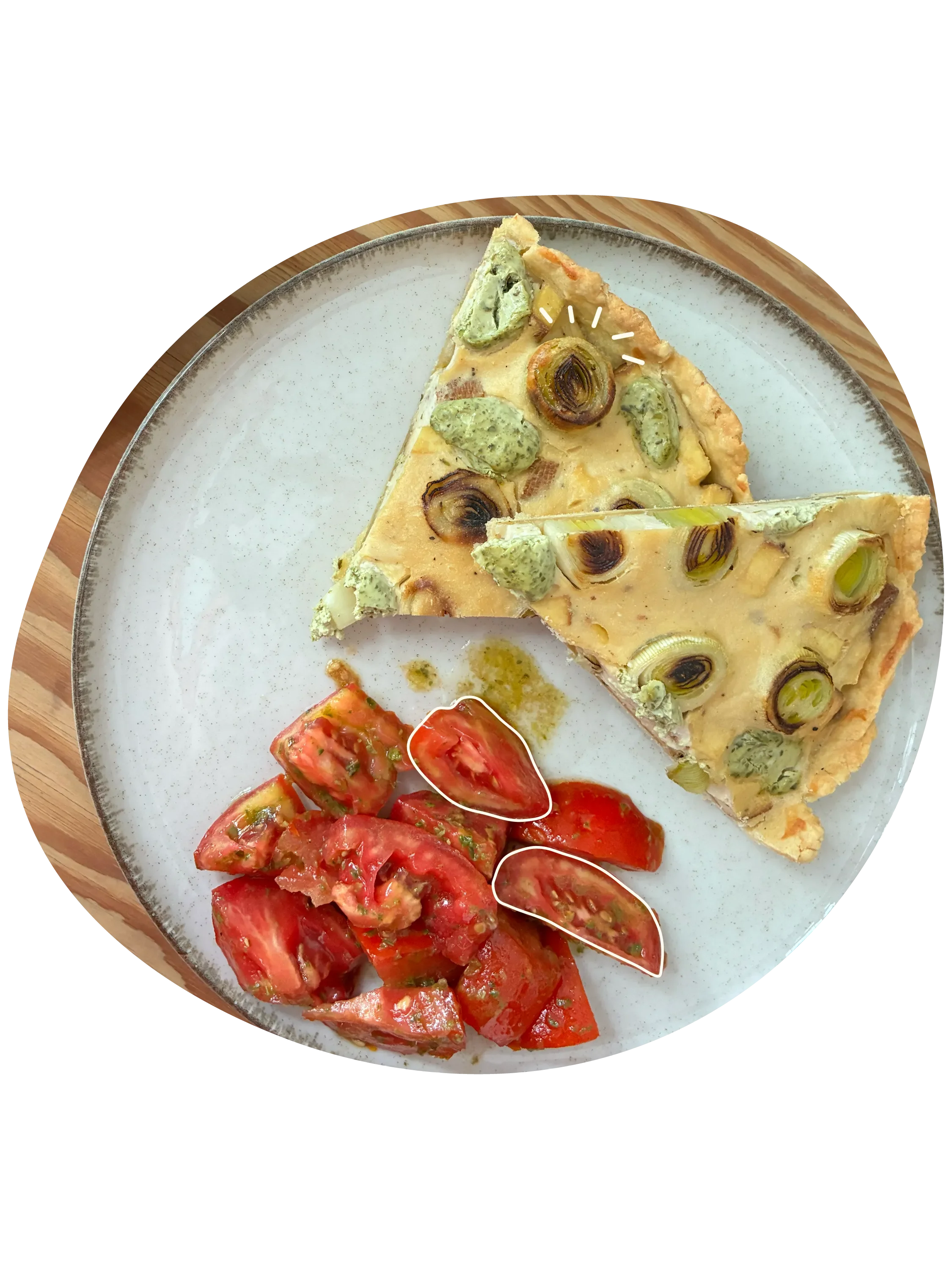 Porción de quiche vegana con puerros, acompañado de tomates cortados en rodajas.
