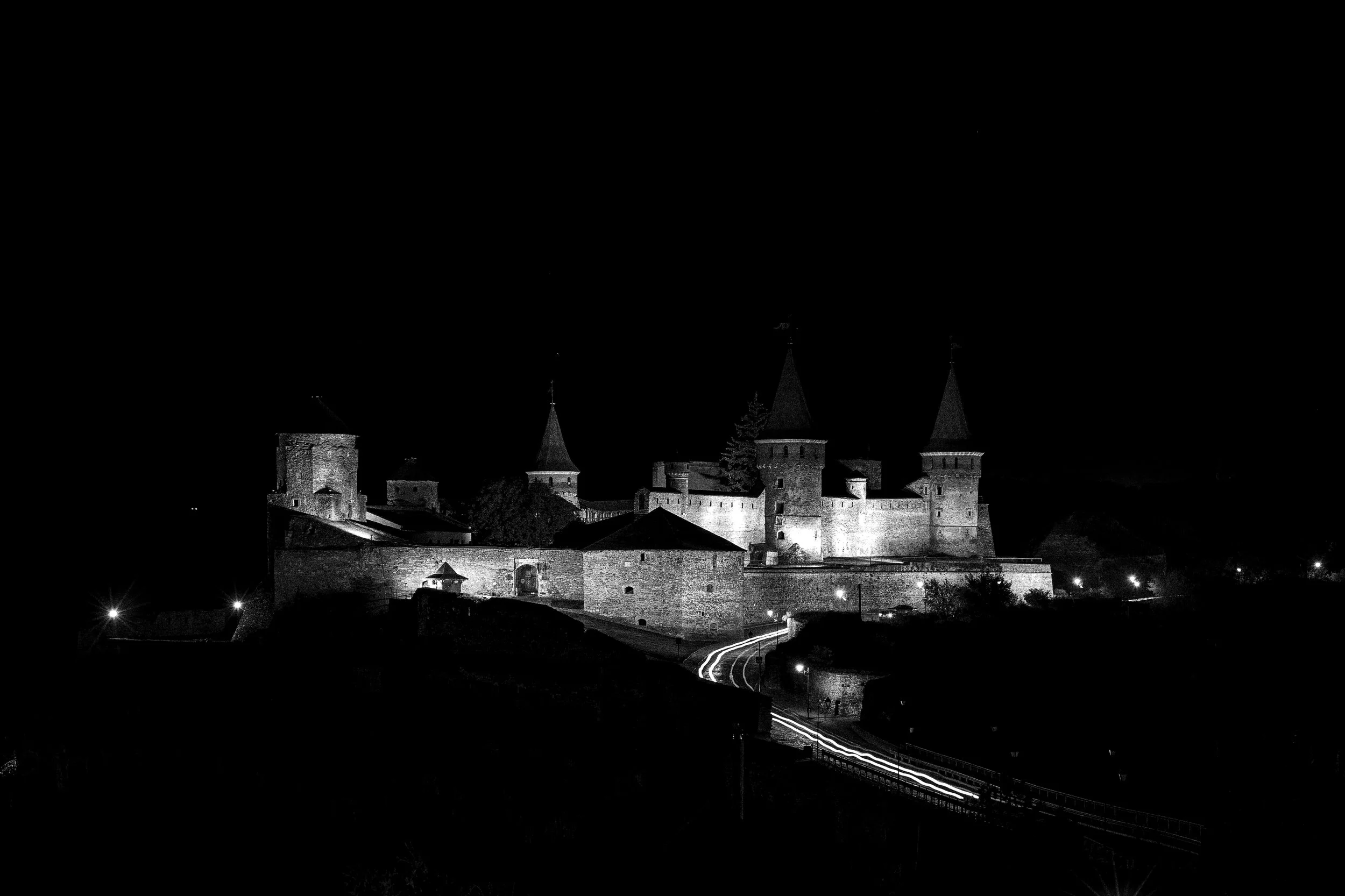 Kamianets-Podilskyi Fortress — night view. The Old Castle stands above the Smotrych canyon and has guarded the approach to the historic city for centuries. Its documented history reaches back at least to the XIV century.
