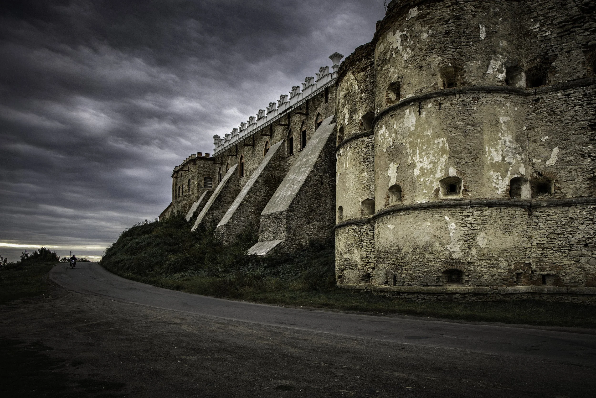 Medzhybizh Castle — defensive walls and bastion. The massive stone fortifications were substantially rebuilt in the XVI century under the Sieniawski family. The walls and towers formed a complex defensive system protecting the approaches to the castl