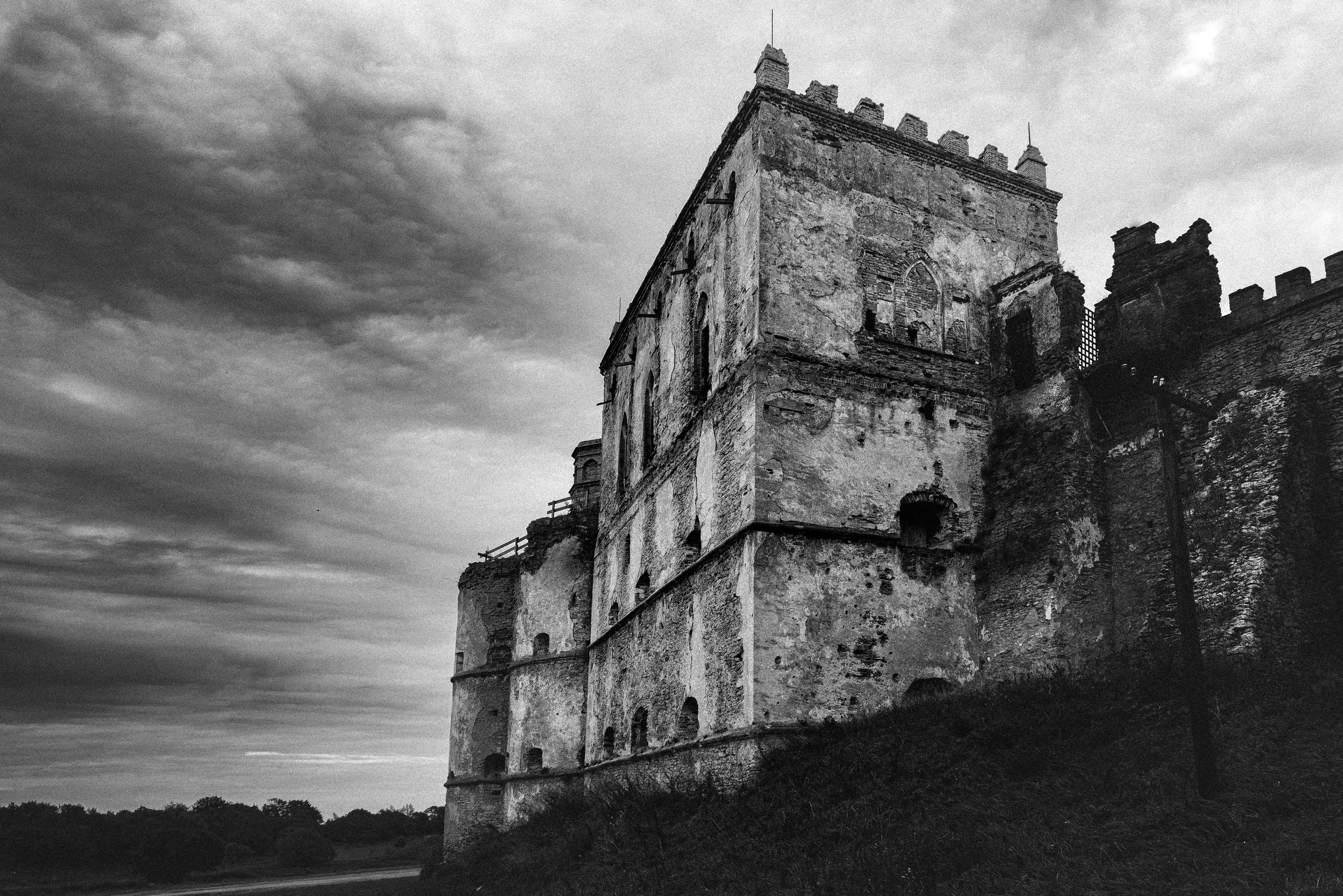 Medzhybizh Castle — in monochrome. Black and white emphasizes the weathered surfaces and gives the image a stronger sense of time, distance, and historical memory.