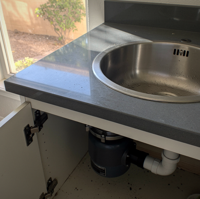 two plumbing sink basins with garbage disposals mounted below