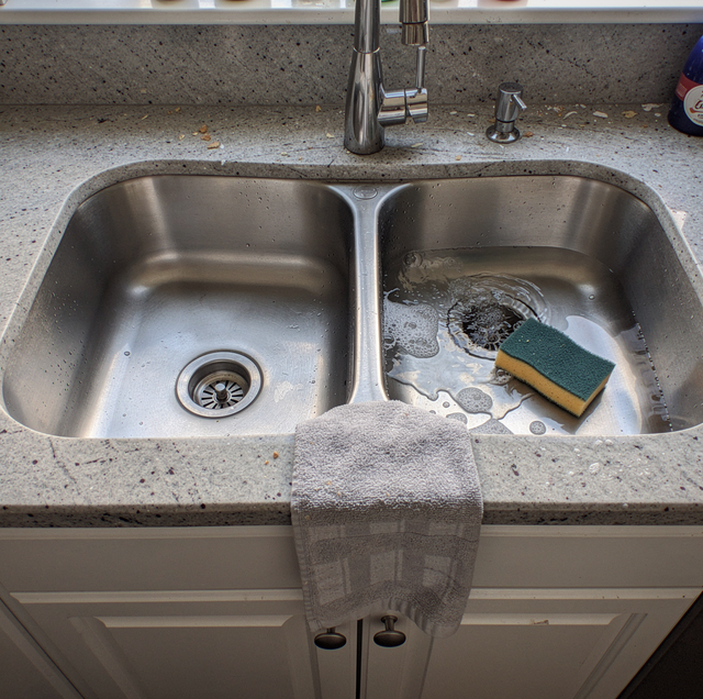 kitchen sink overflowing from adjacent drain bowl
