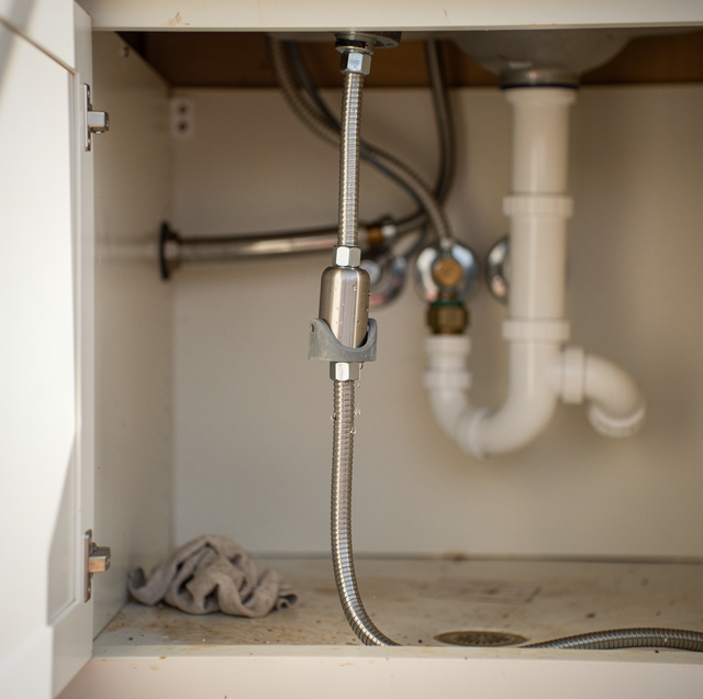 hose weight clipped under kitchen sink cabinet