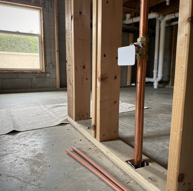 open copper supply lines stubbed through wall studs