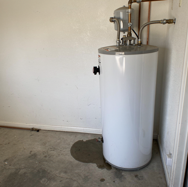 plumber disconnecting old water heater copper pipes