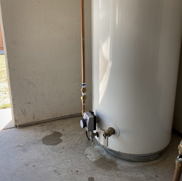 plumber inspecting exposed copper pipes with clipboard