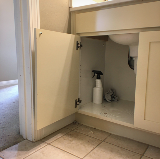 copper repipe pipes exposed behind open bathroom vanity