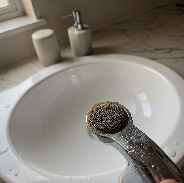 carbon whole-home water filter beside main supply pipe