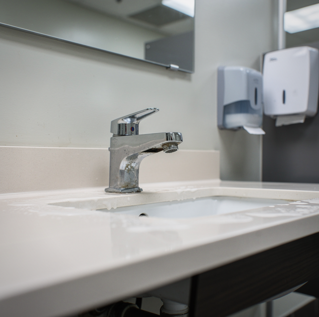 Worn commercial restroom faucet handle loose on sink