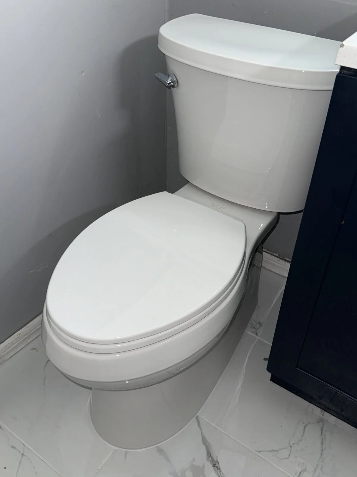 toilet tank with open lid showing worn flapper chain