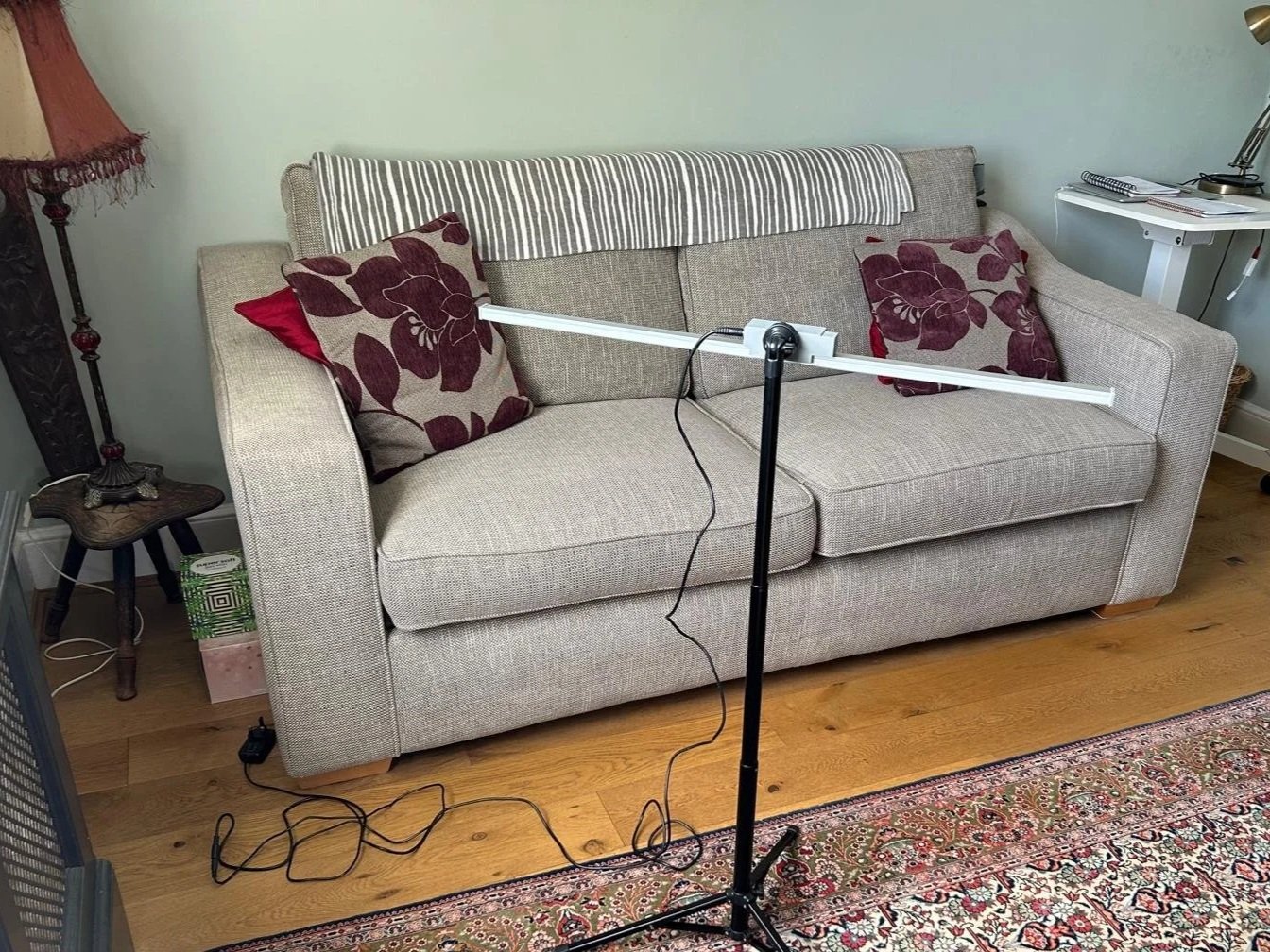Sofa in the therapy room of Jayne Louise Street, M.A., showing a lightbar for Eye Movement Desensitisation Reprocessing (EMDR)