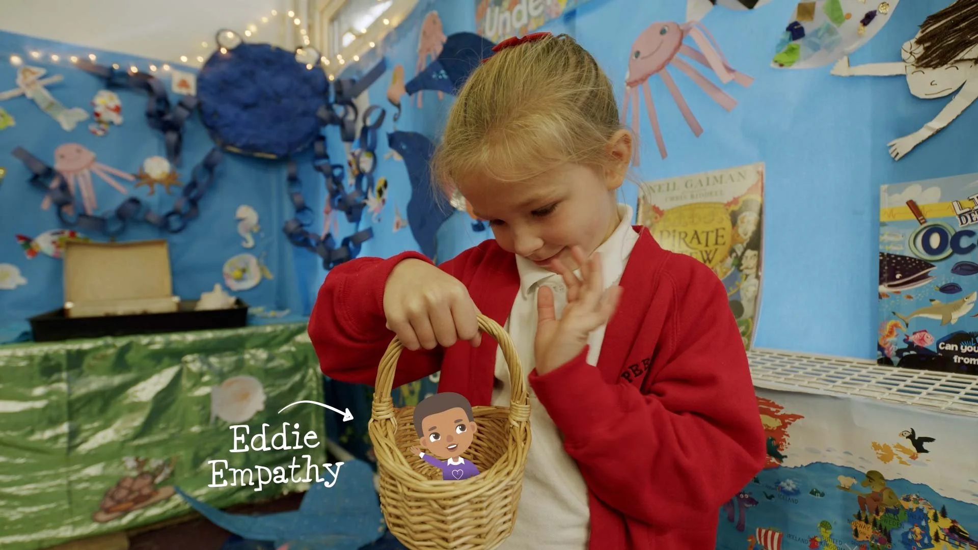 Child playing and waving to Eddie Empathy character