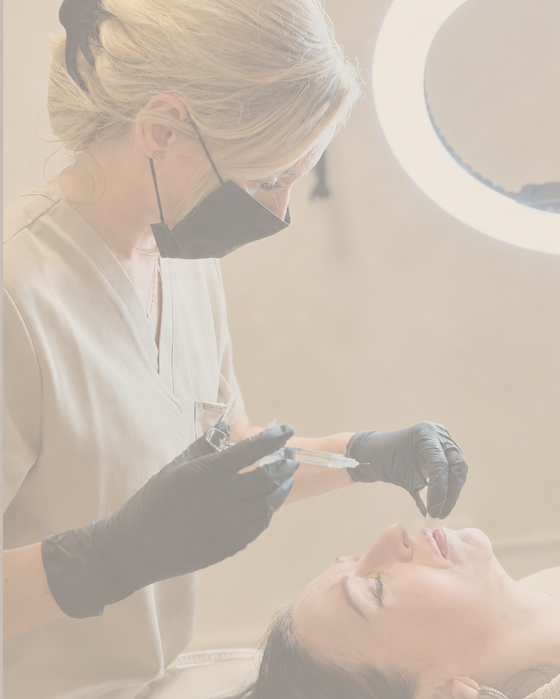 A healthcare professional administering an injection to a patient lying down in a clinical setting with bright lighting.