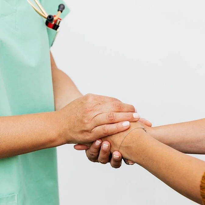 holding hands with patient