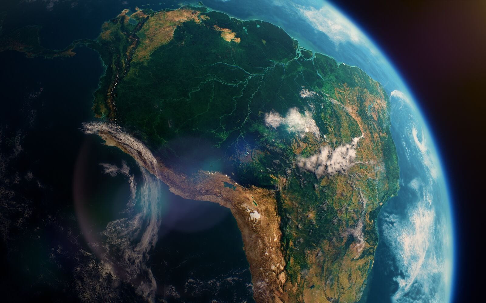 Satellite view of South America showing green forests, rivers, mountains, and the Atlantic Ocean along the eastern coast.