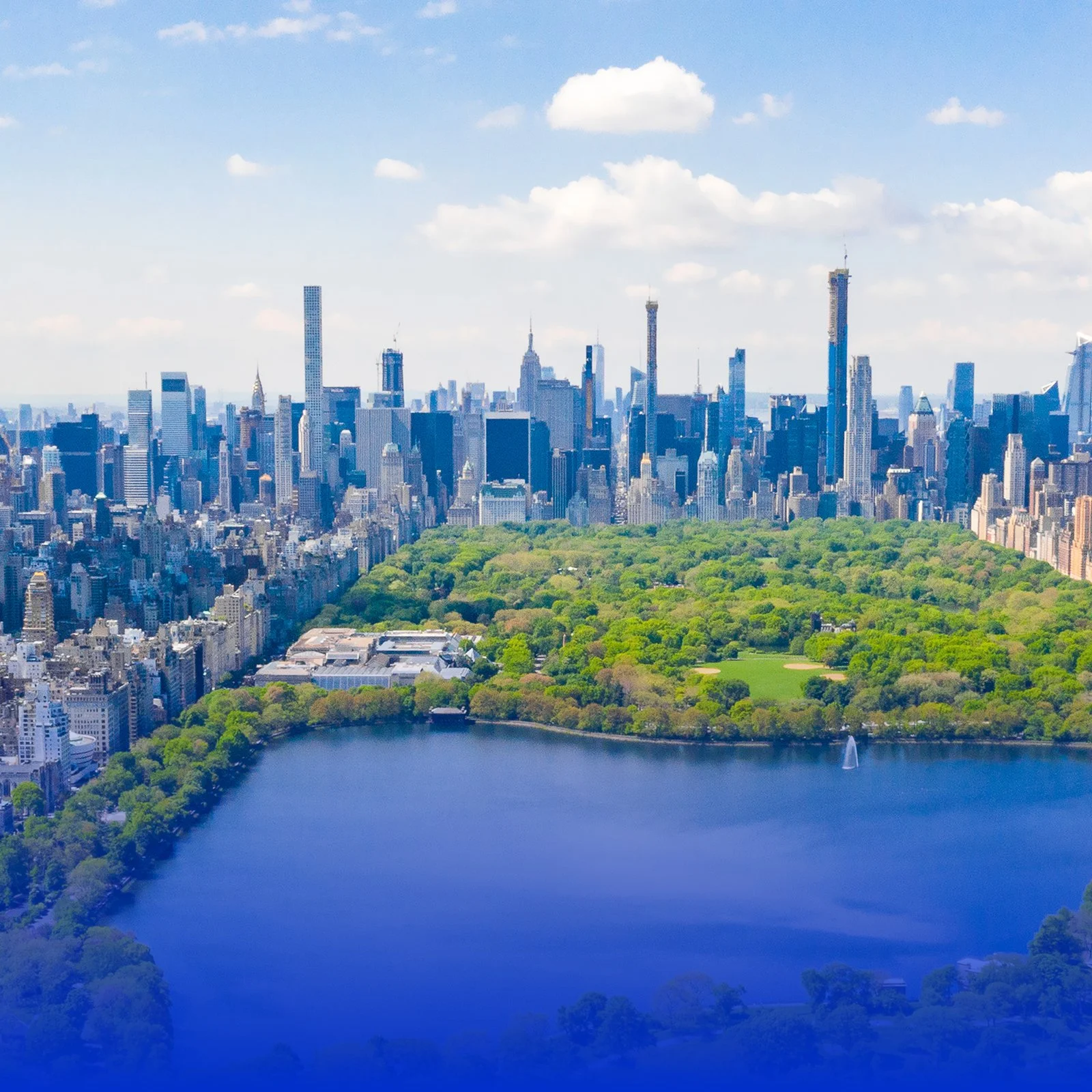 Aerial view of Central Park with surrounding skyscrapers in New York City during the day.