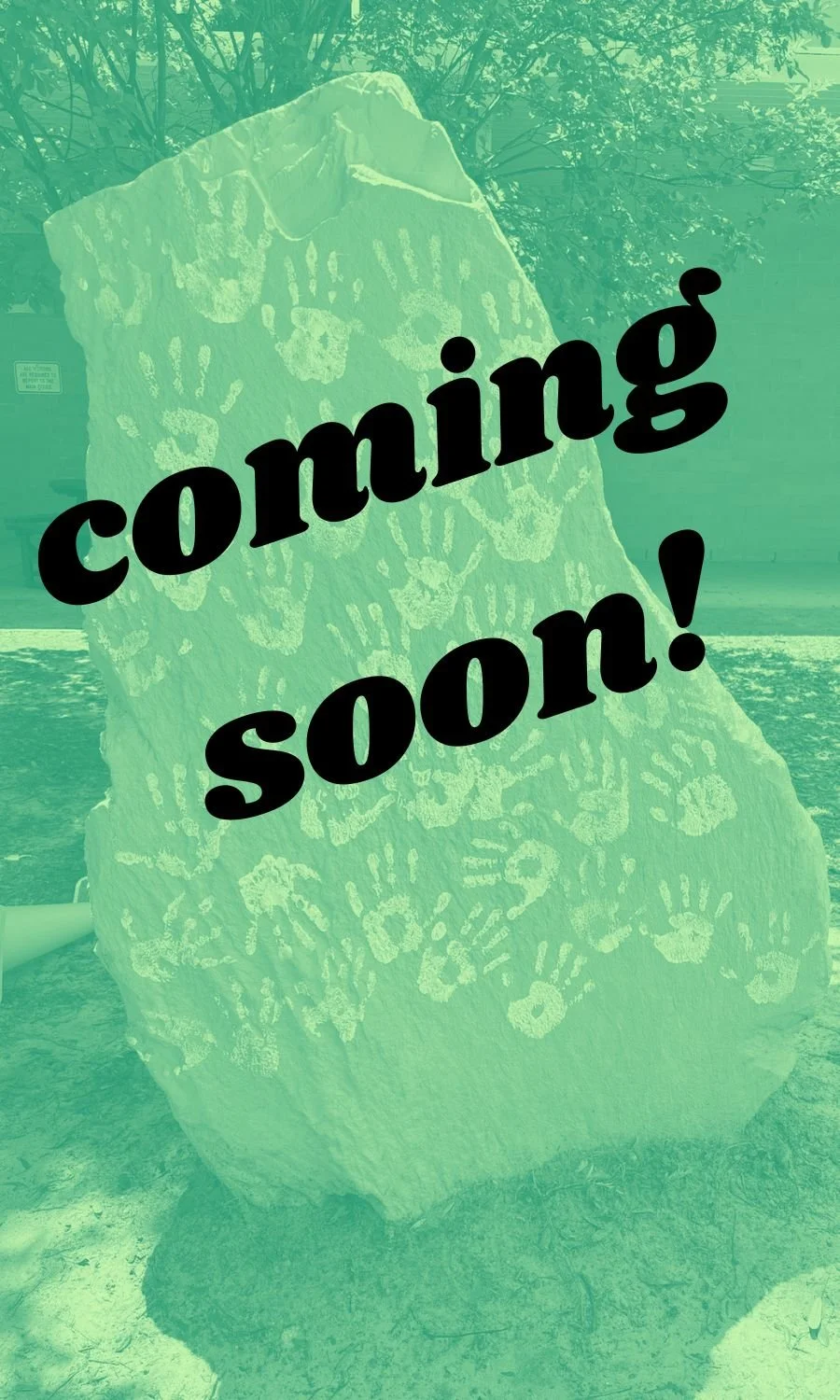 A large rock with handprints and a dinosaur face engraving, with the text "coming soon!" overlaid.