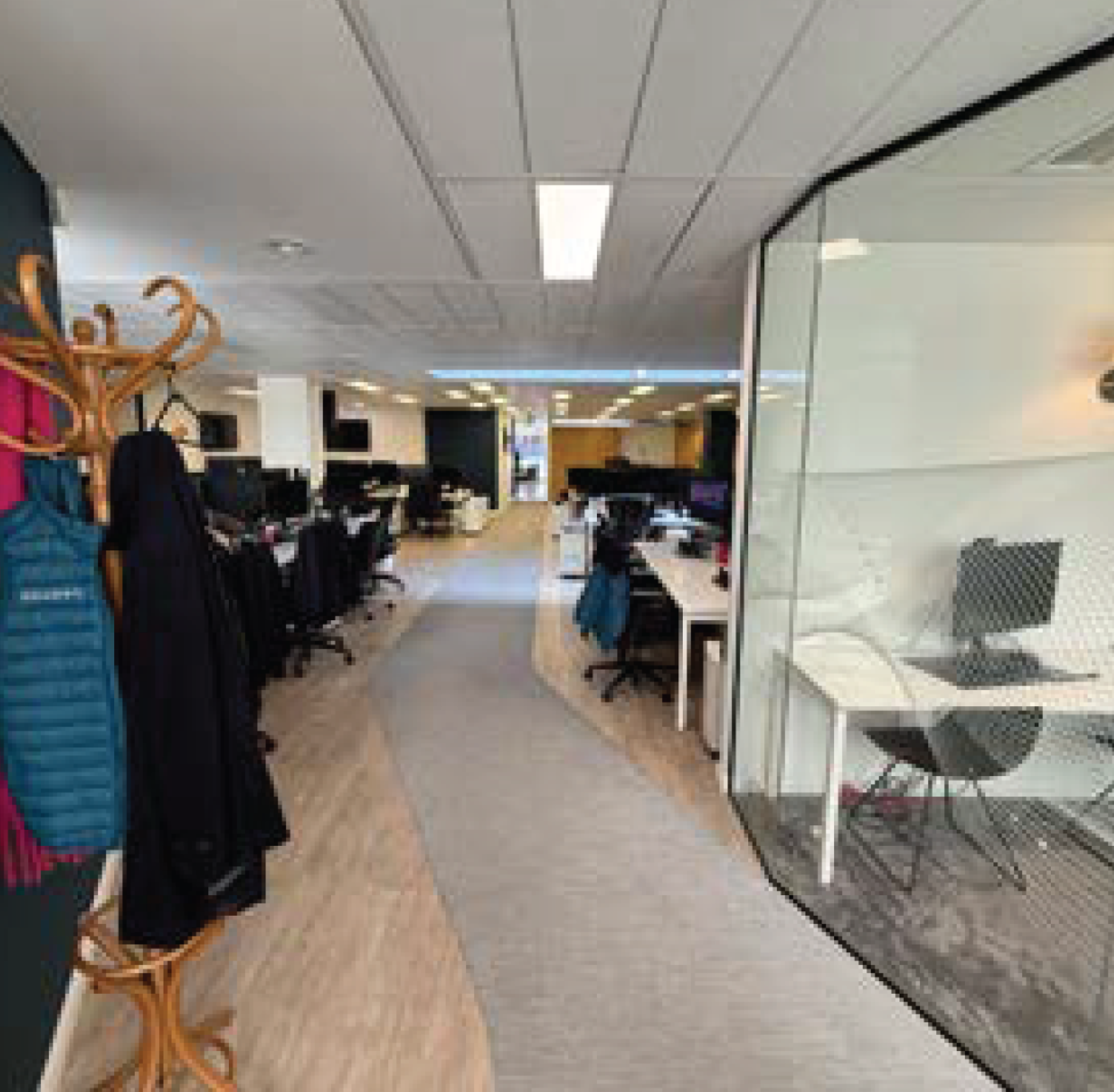 The image shows the interior of a retail store or mall with jewelry display cases, clothing racks, and mannequins. The ceiling has rectangular fluorescent lights, and the floor appears to be tiled. There is a large mirror on the right side reflecting part of the store.