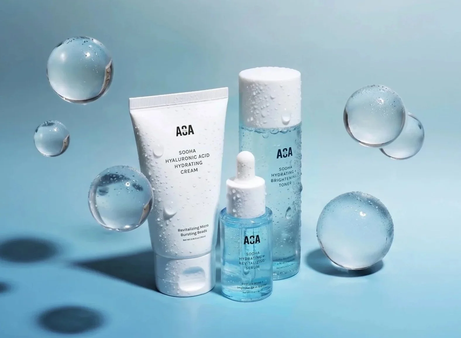 Image of the AOA Skin Sooha Collection (cream, toner, and serum)  on a blue background