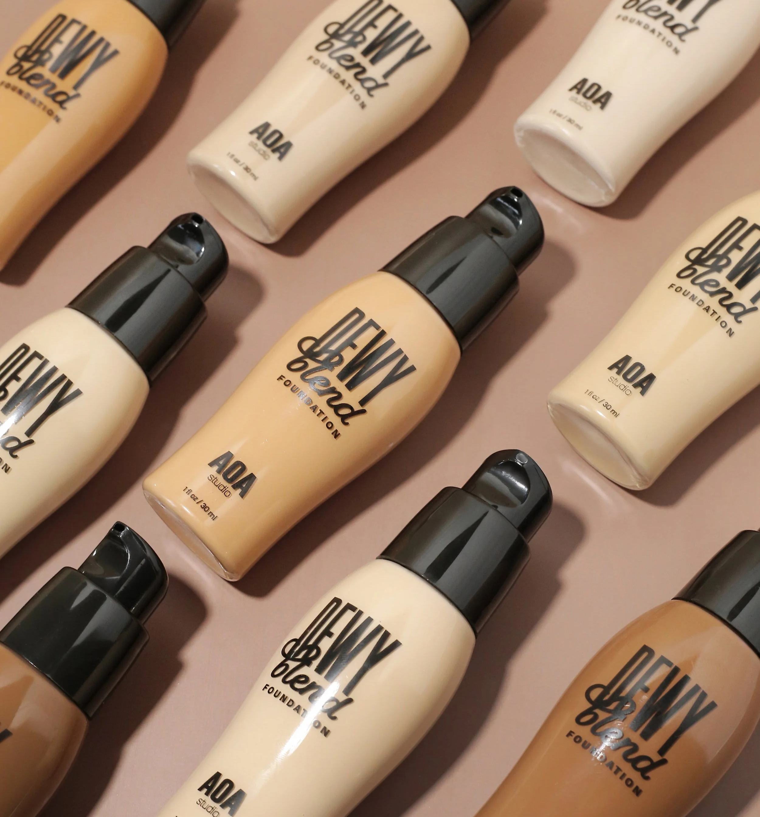 A style image of the AOA Studio Dewy Foundation in a variety of shades