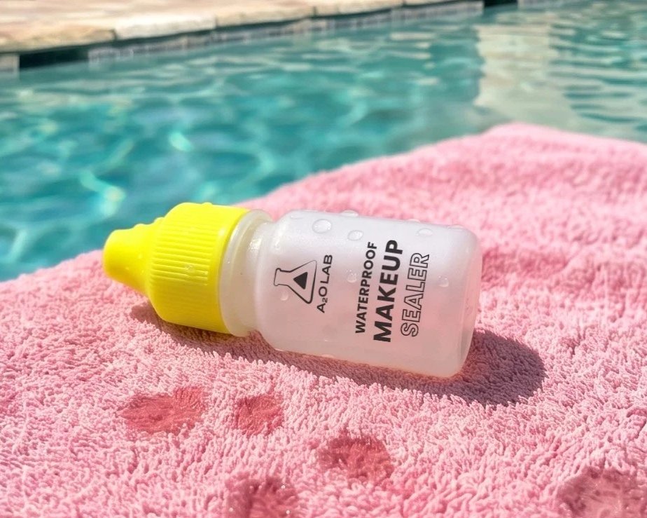 A poolside styled image of the A2O Lab Waterproof Makeup Sealer