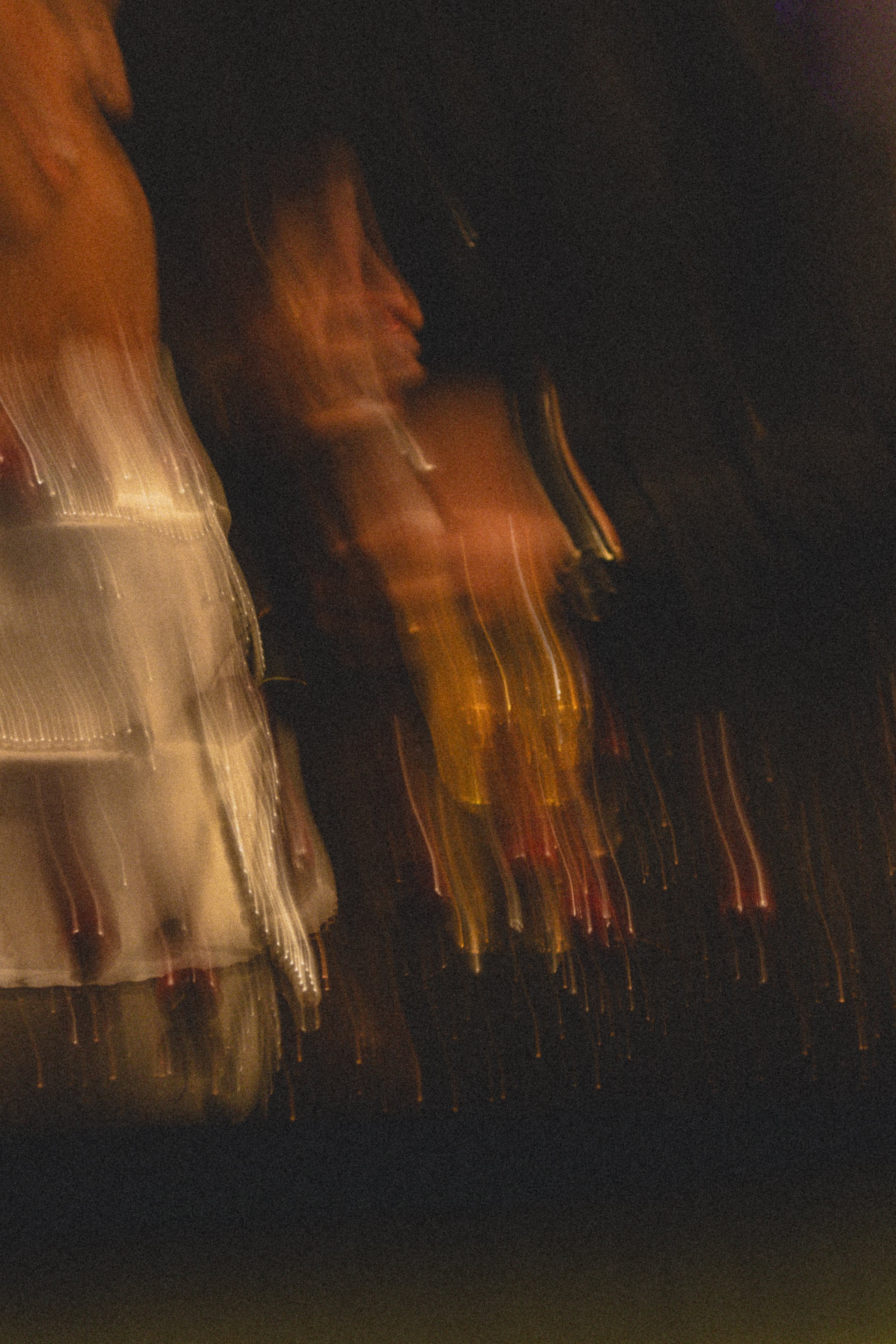 Blurry photo of moving cars at night with streaks of light from headlights and taillights.