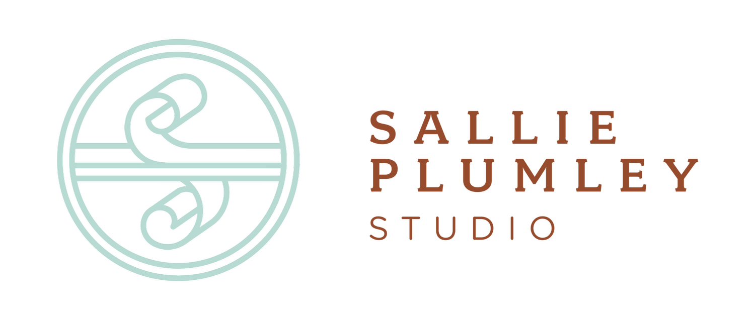 Logo of Sallie Plumley Studio with a circular design featuring a stylized ribbon or paperclip and the studio's name in brown text.