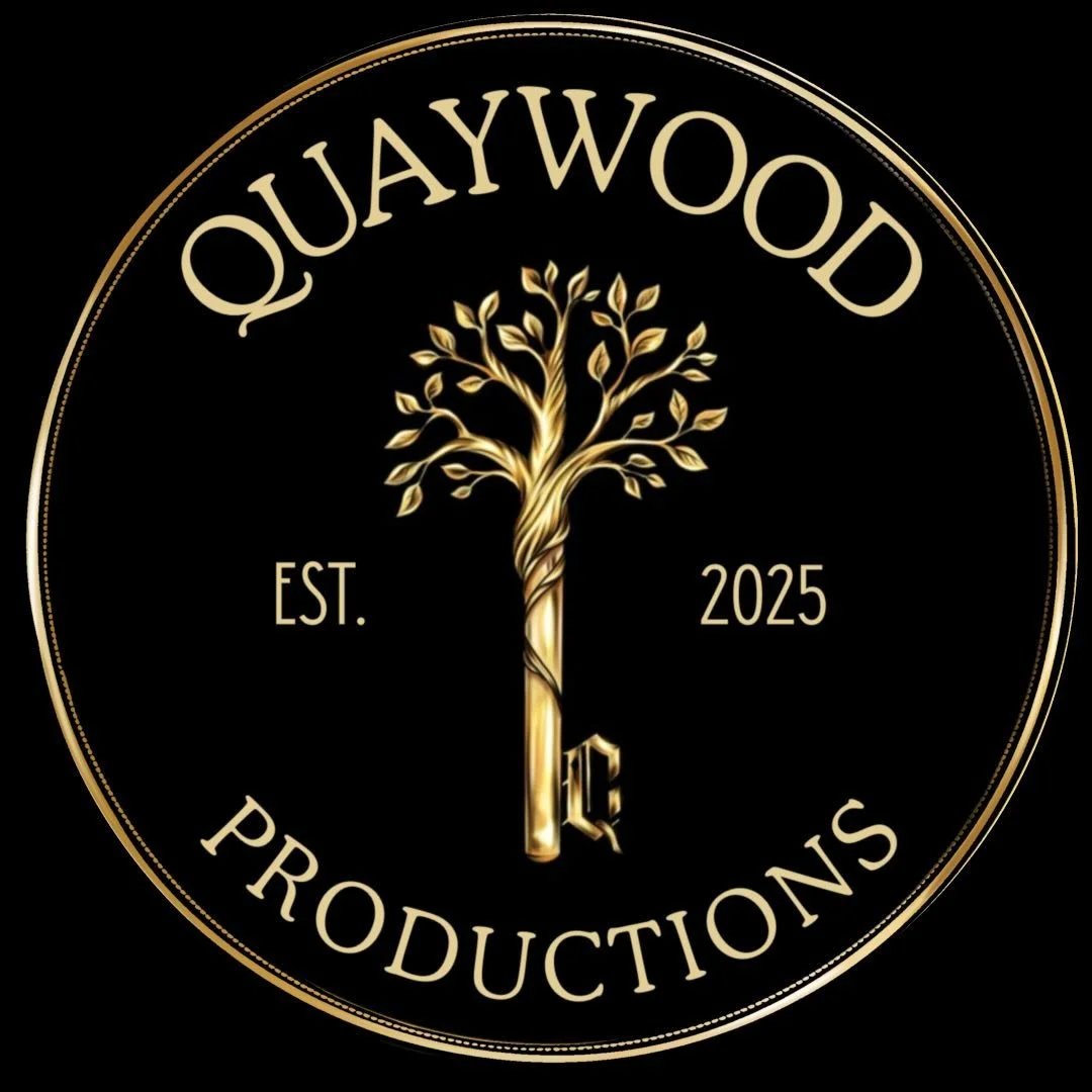 A black circular logo with gold accents for QuayWood Productions, featuring a stylized tree with intertwined trunk, the words "QuayWood Productions" around the top and bottom, "Est. 2025" and a gold letter "R" in the center.