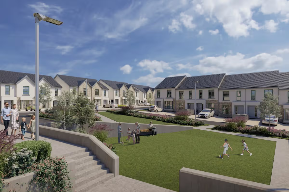 A residential neighborhood with modern townhouses, green lawns, and families enjoying outdoor activities on a sunny day.