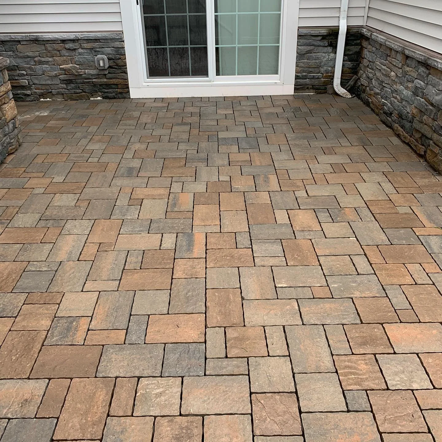 Entry way patio in Hingham with a Techo-bloc Mista paver. We like to wait until the weather dries out before filling in the joints. This makes for a stronger and cleaner finished product! #landscapedesign #landscape_love #landscapeconstruction #lands