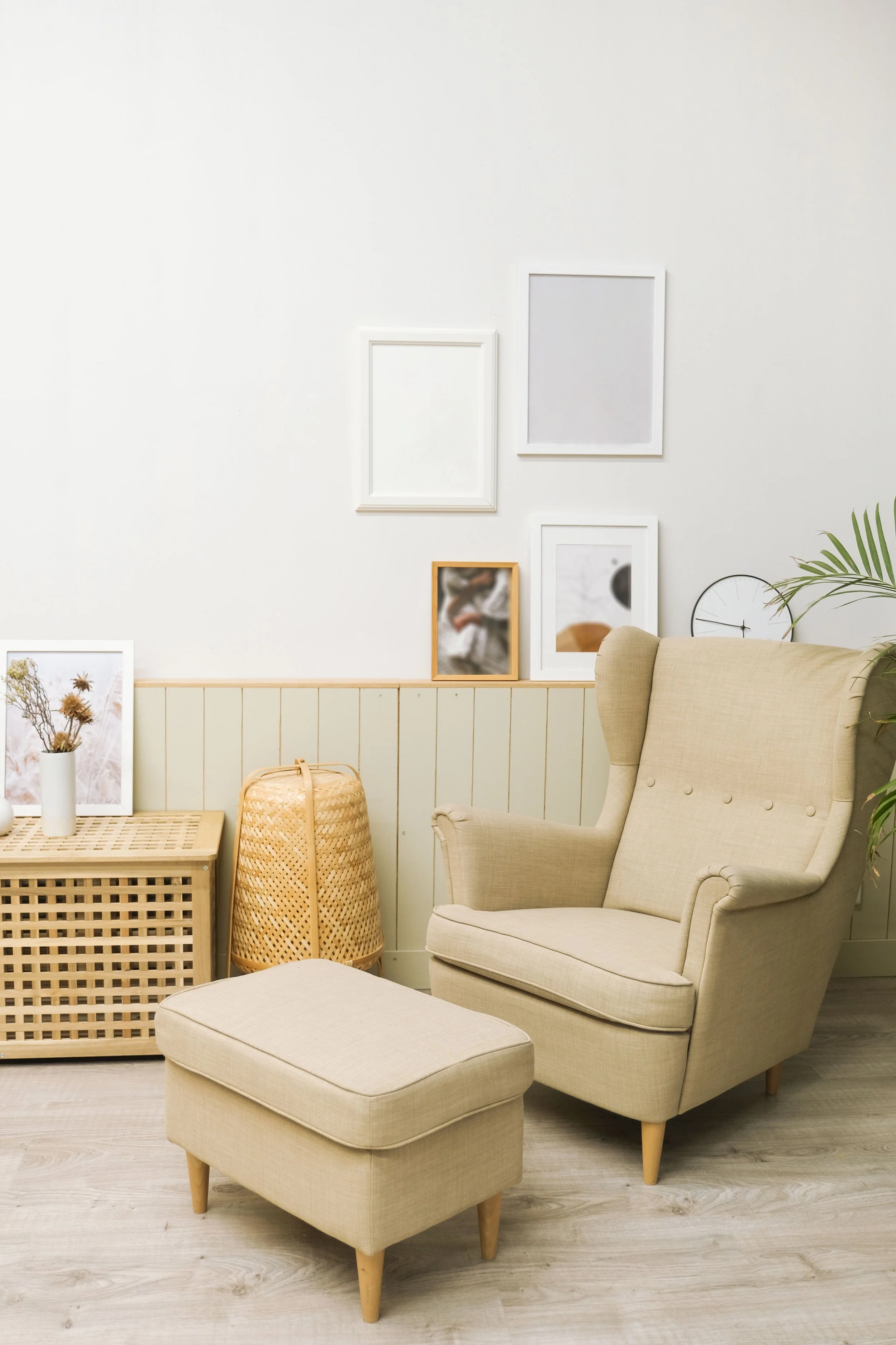A comfortable cream chair and foot rest in a therapy room with cream coloured walls