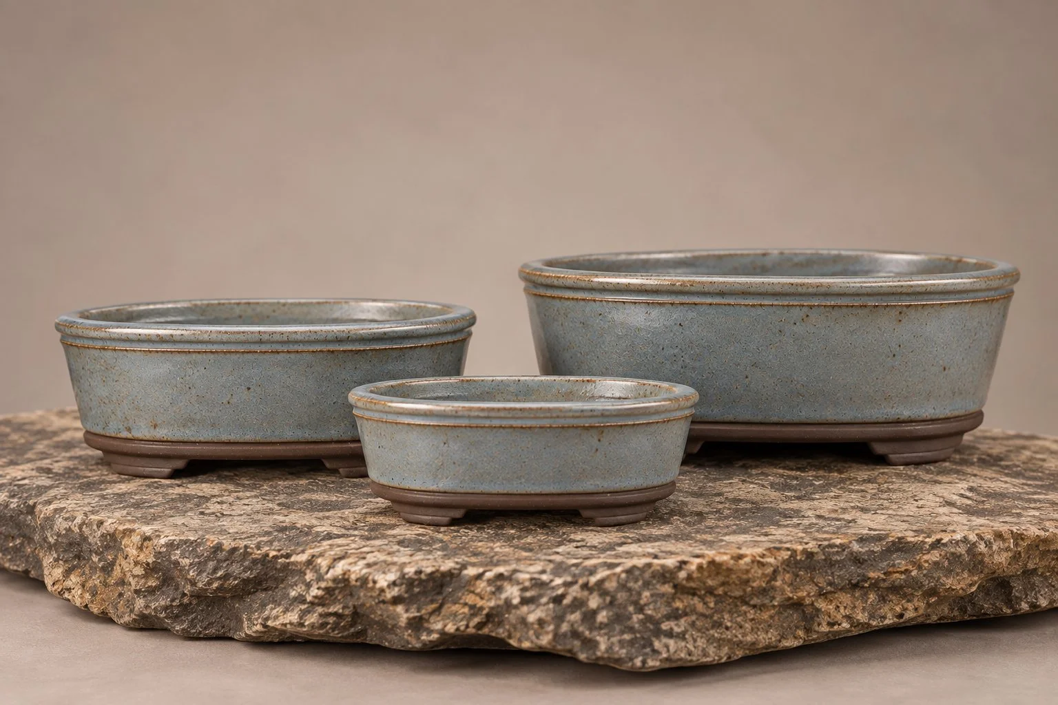Three handcrafted oval bonsai pots in Sea Foam, featuring the Angled Crown design, by Ian Jobling Ceramics.