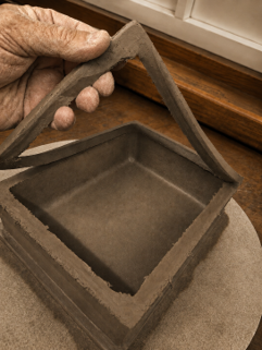 Hand trimming the top of a rectangular bonsai pot ensures flatness prior to rim carving.