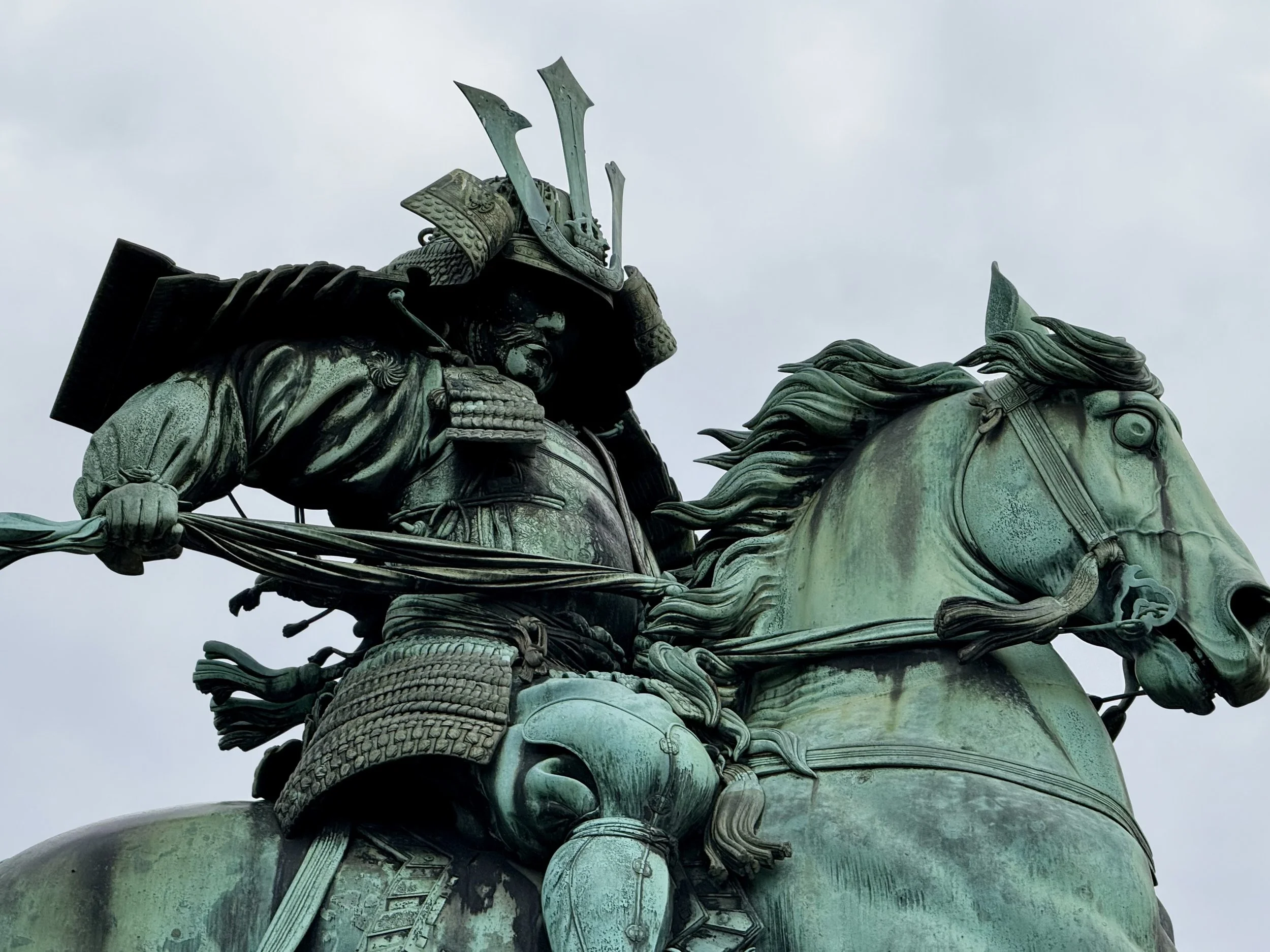A statue of a Samuri Warrior on horse back in the gardens of Tokyo's Imperial Palace