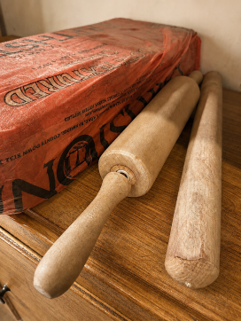 Pottery tools including rolling pins used in the studio to shape clay slabs.