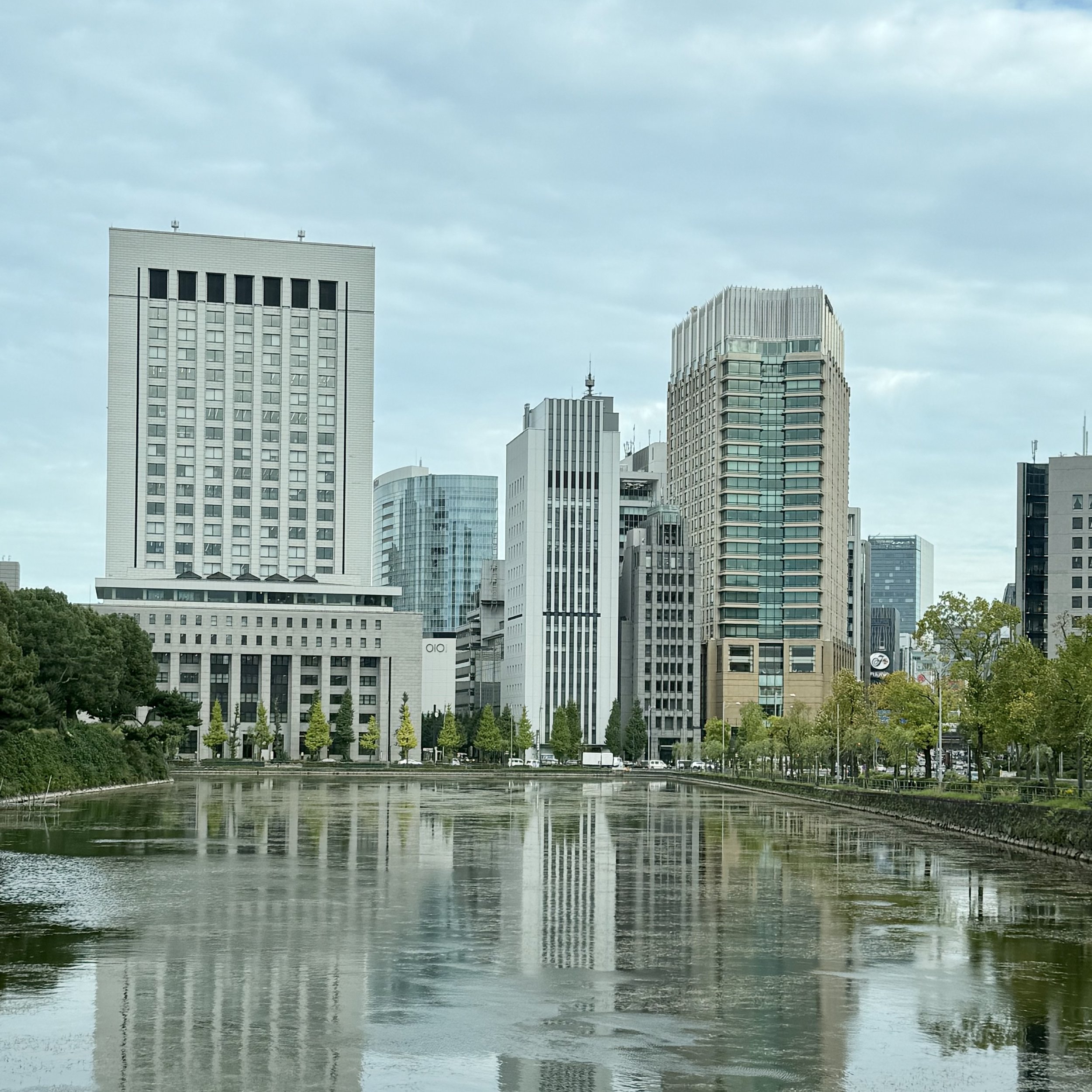 Image of the Tokyo skyscrapers reflected in the lake of Tokyo Imperial Palace
