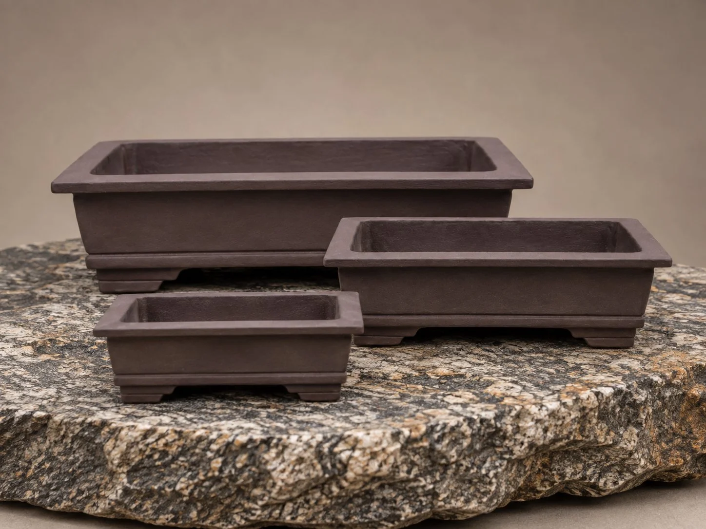 Three handcrafted rectangular bonsai pots in Sea Kelp, featuring the Wide Crown design, by Ian Jobling Ceramics.