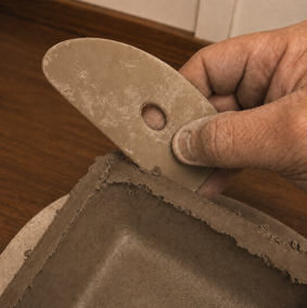 Ian Jobling hand-trimming a slab built bonsai pot.