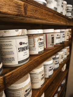 Shelves of ceramic glazes used in Ian Jobling's pottery studio.