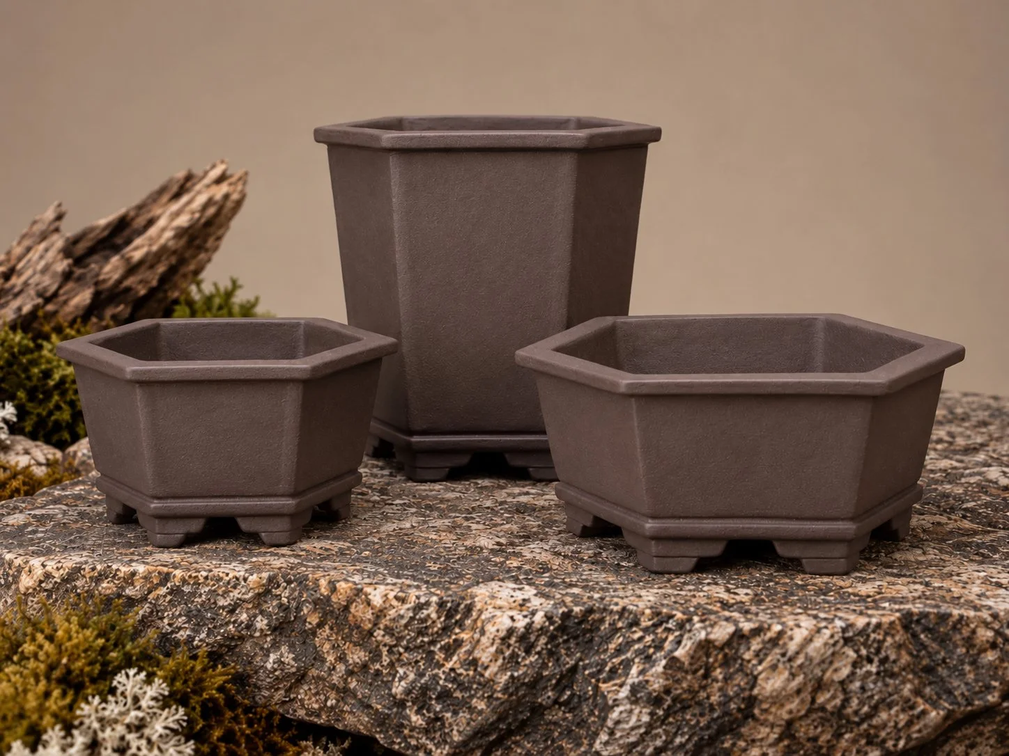 Three handcrafted hexagonal bonsai pots in Sea Kelp, featuring the Wide Crown design, by Ian Jobling Ceramics.