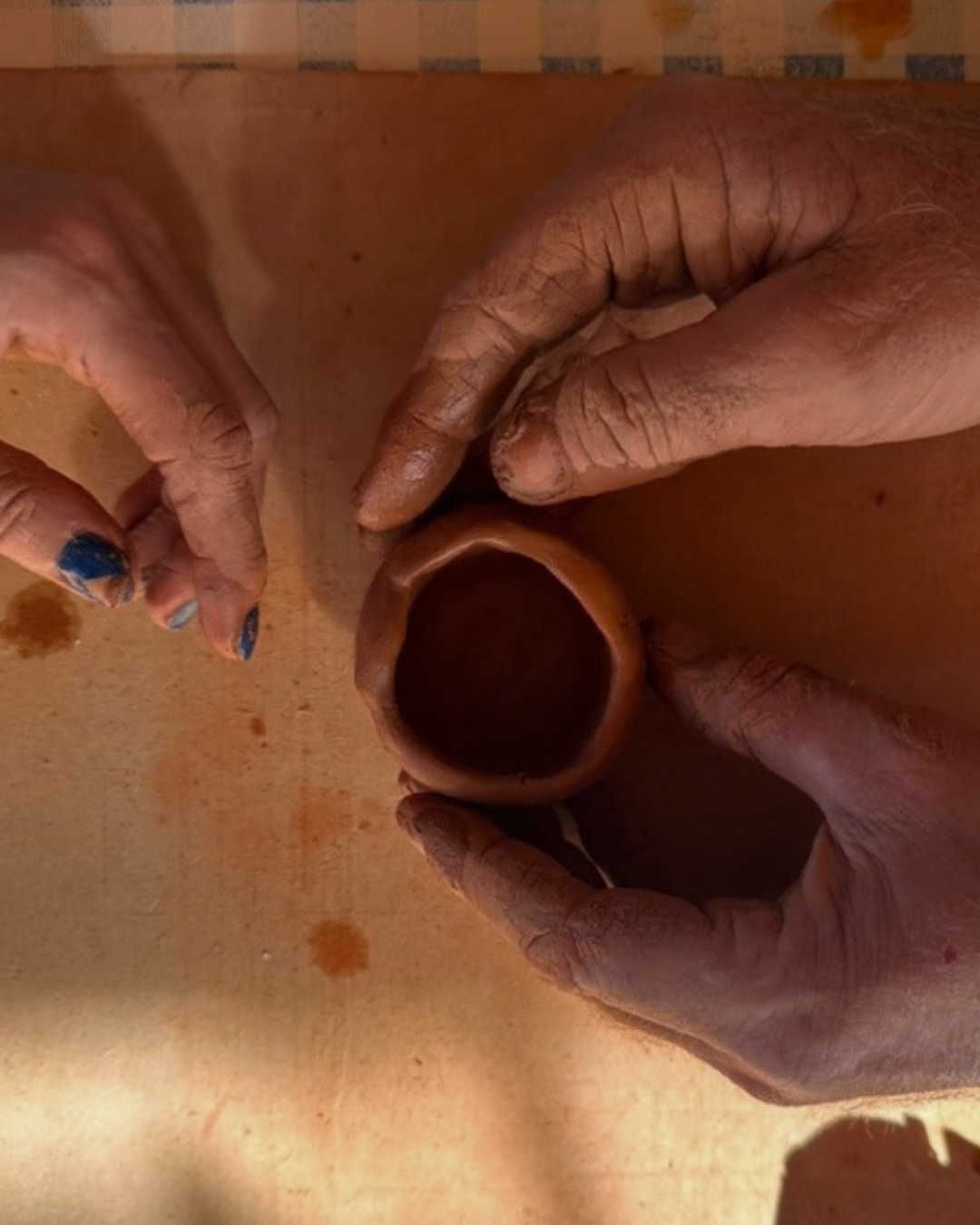 Pinching a small terracotta pot by hand: hand building at the retreat