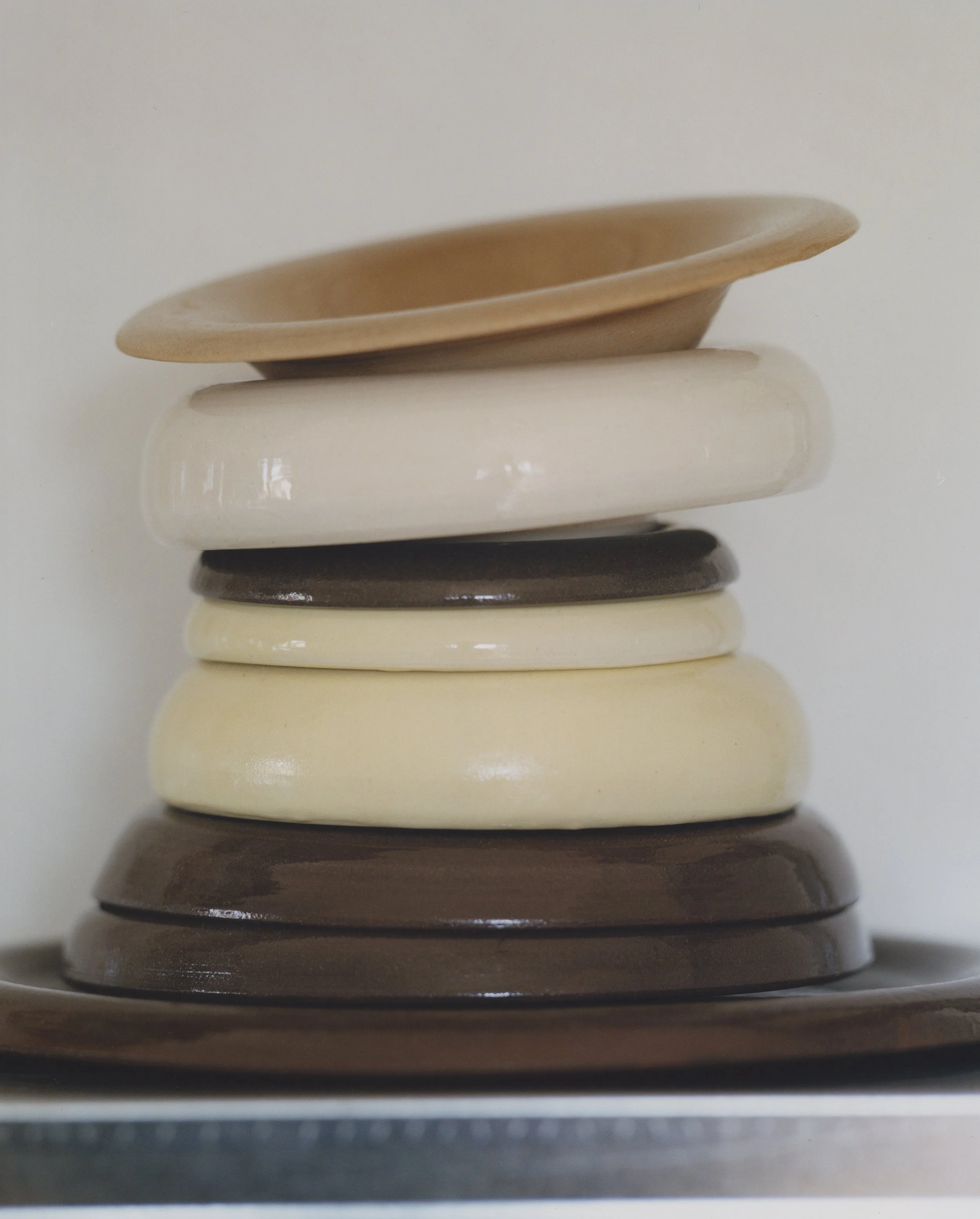 Stack of pigmented ceramic plates by Chiara Caselli