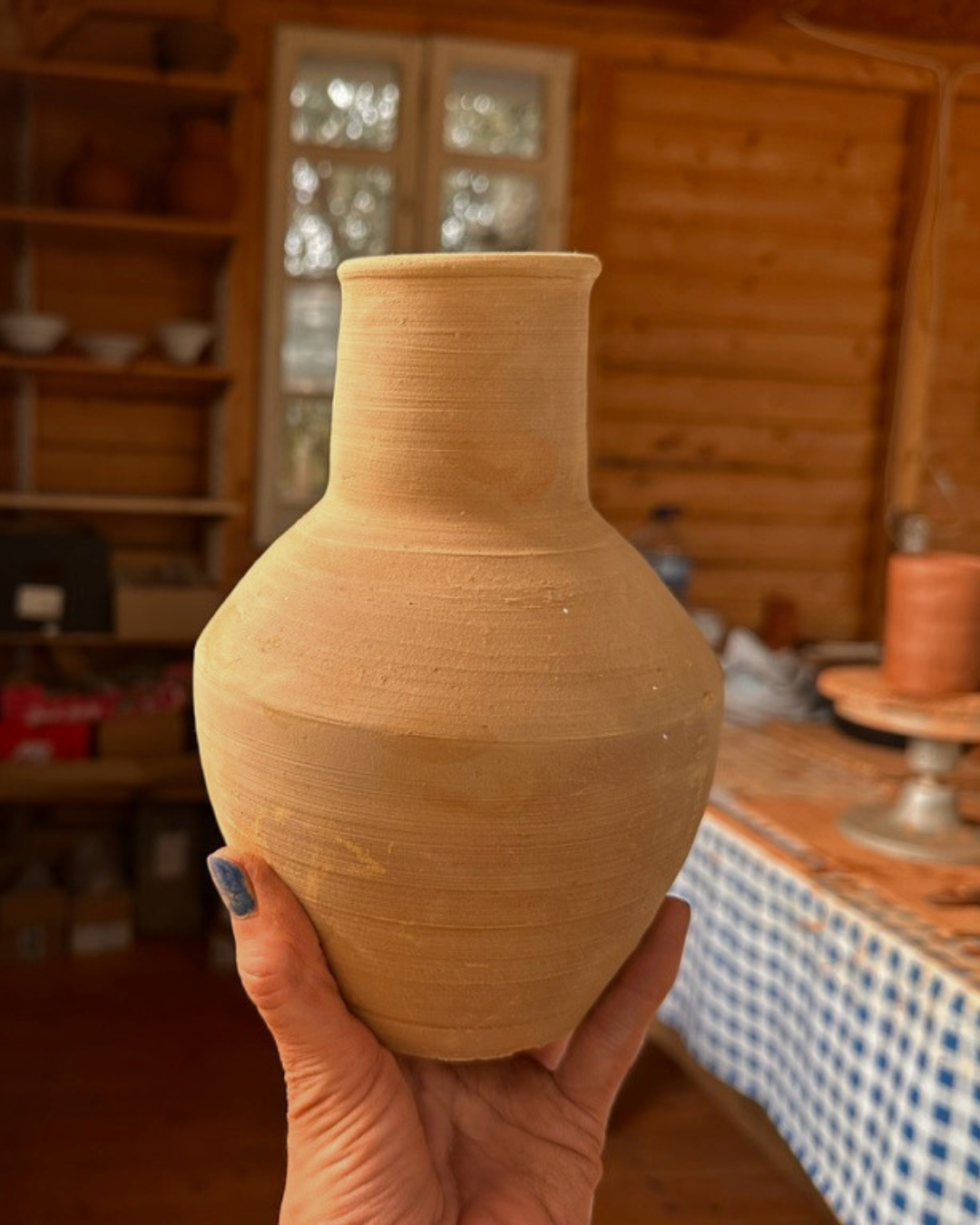 Tall terracotta vase made during a hand building course