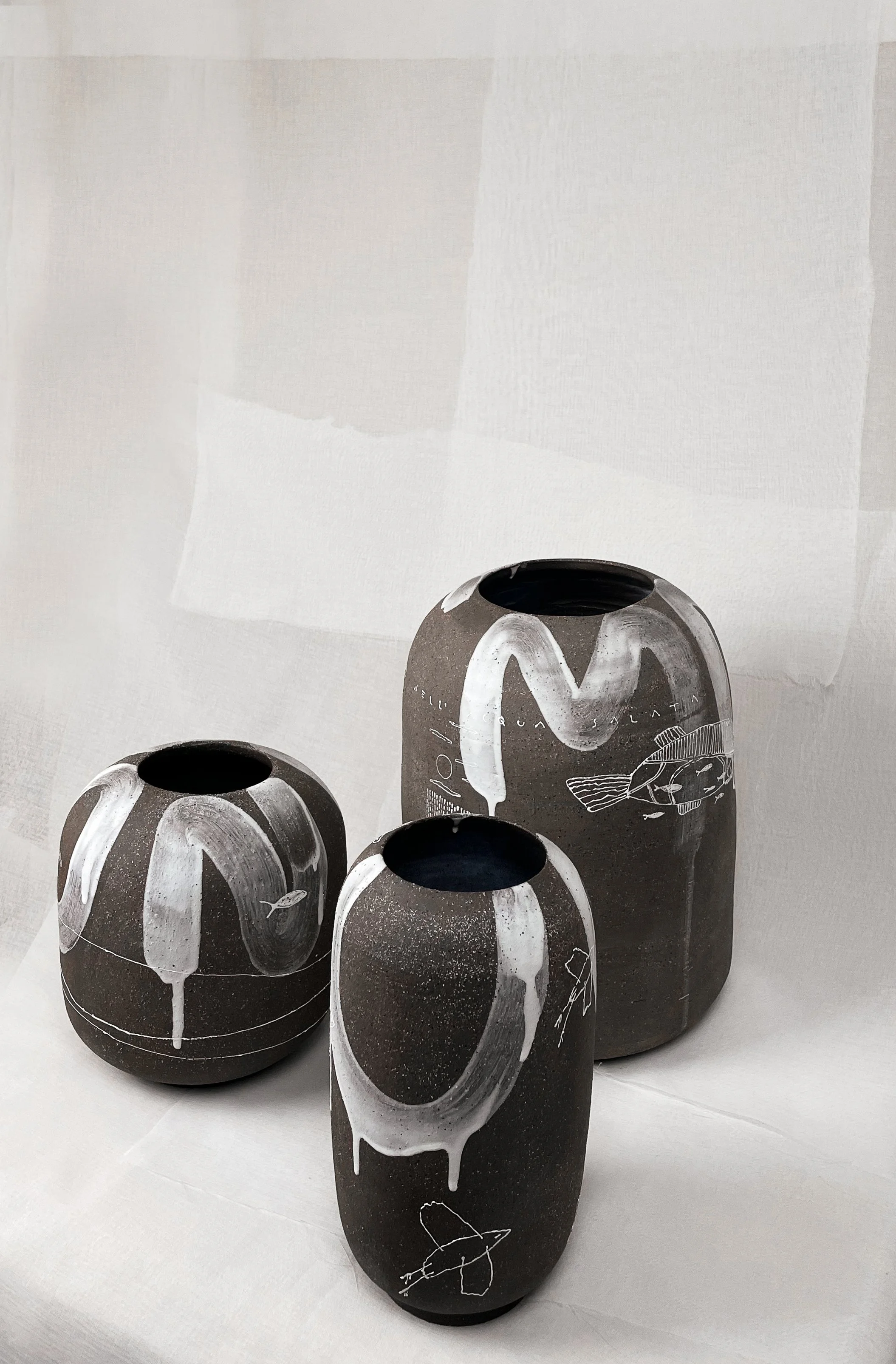 Black ceramic vases with white lava glaze by Chiara Caselli