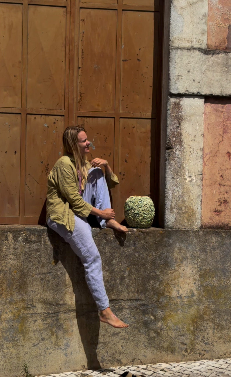Ceramicist Masha Bezuglaya holding one of her pieces