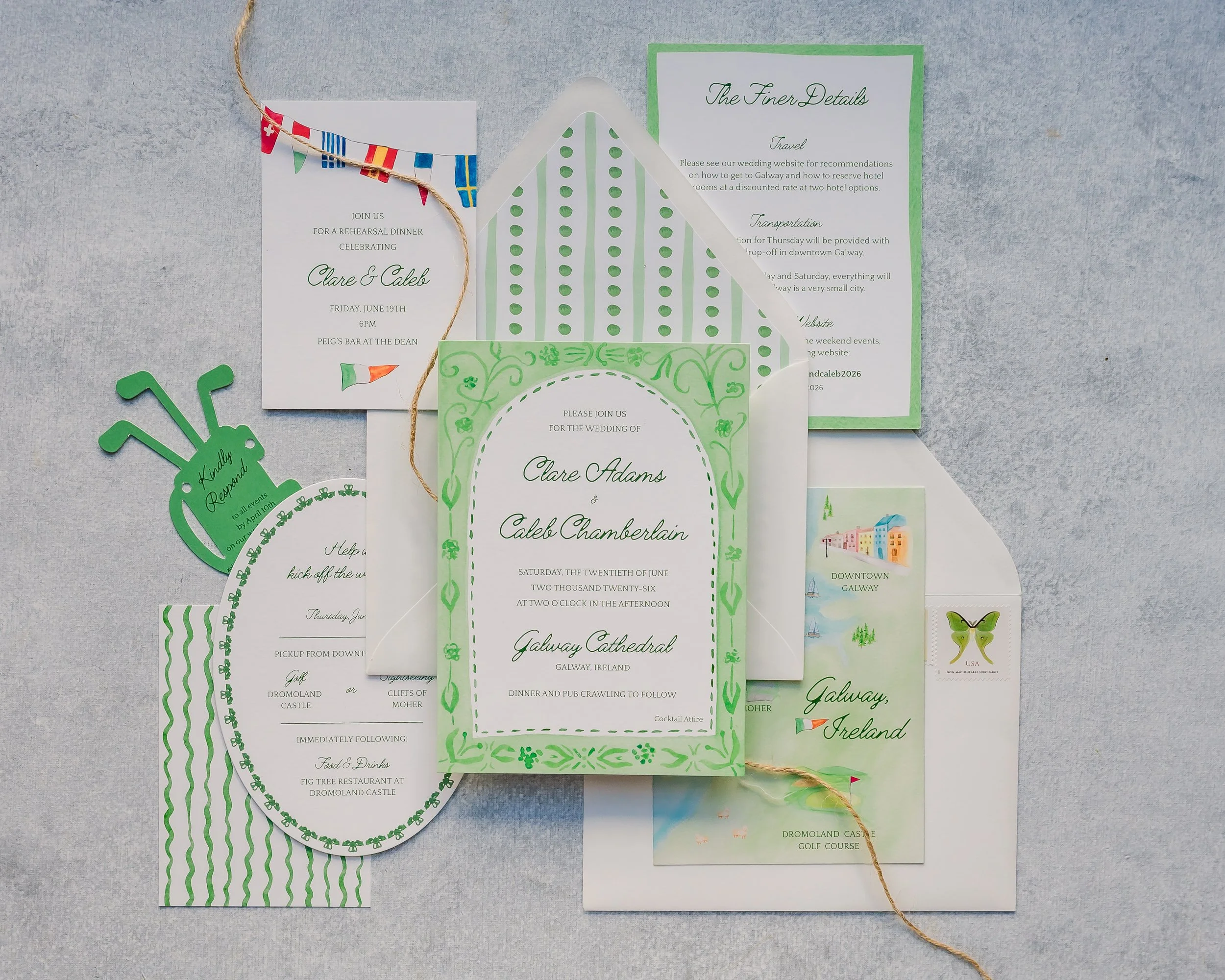 A flat lay of wedding invitations and related paper items, including green, white, and illustrated cards, with colorful bunting and a string. The invitations feature elegant text about the wedding of Clare Adams and Caleb Chamberlain, with details about the event date, location, and plans, set against a light gray background.