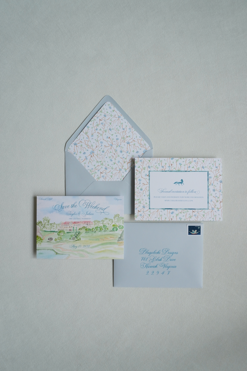 Set of wedding stationery including a save the date card, invitation card, envelope, and RSVP card with a light blue theme and floral accents.