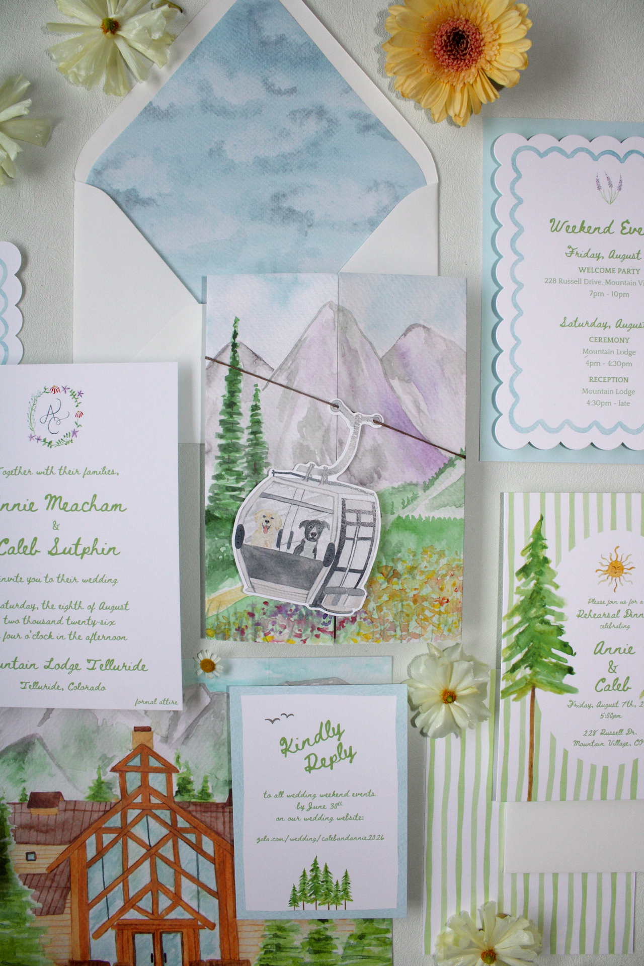 Various wedding invitation cards and watercolor illustrations of mountain landscapes, trees, and a gondola with dogs inside, decorated with white flowers.