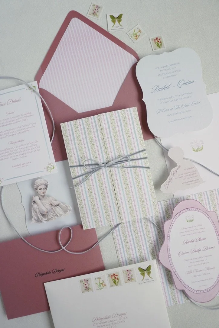 Collection of elegant wedding stationery, including invitations, RSVP cards, and envelopes in soft pink and pastel colors, decorated with floral and butterfly motifs.