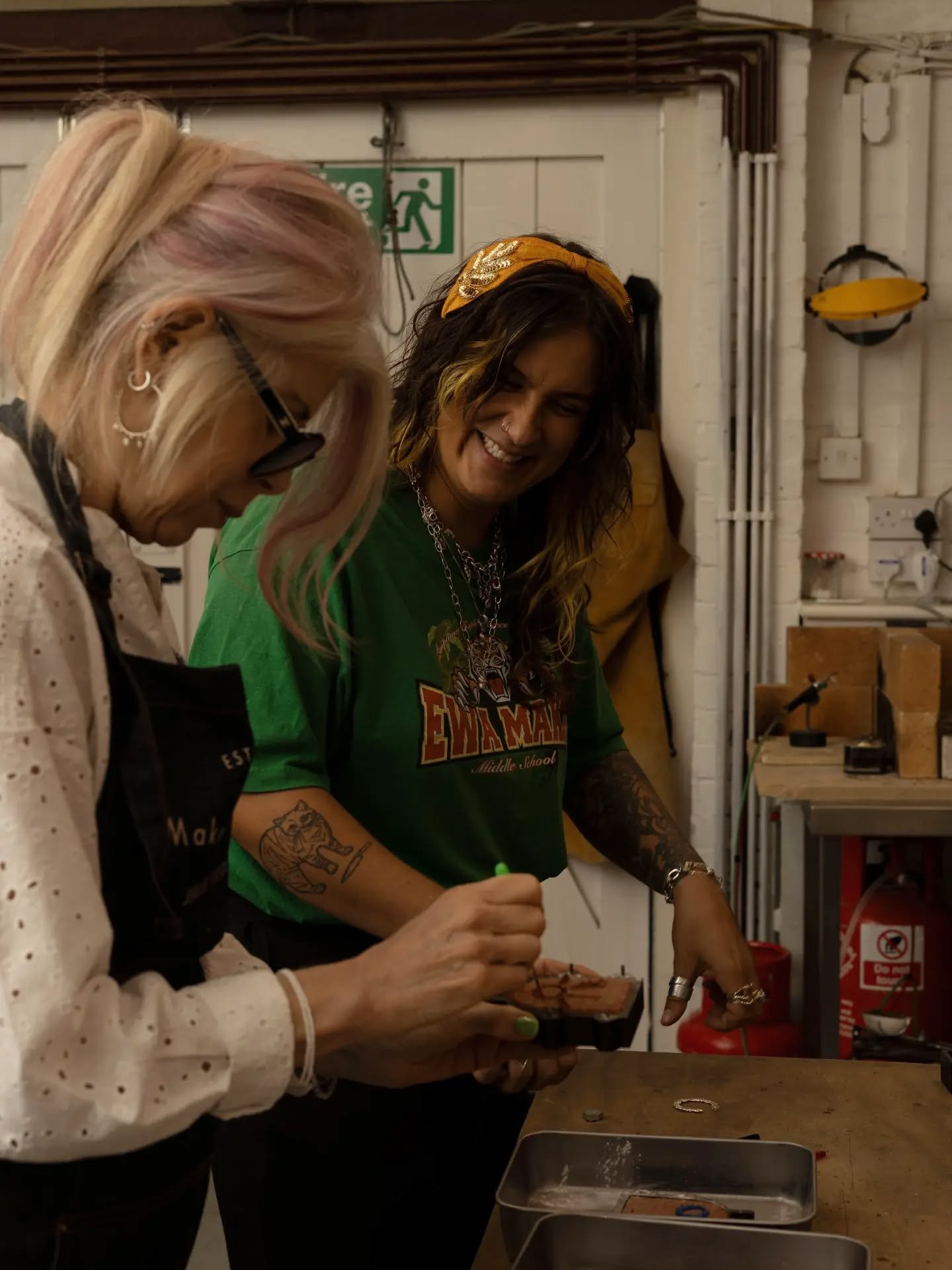 You can see the joy in my face that sandcasting brings me. For me, sandcasting is like getting a film camera or disposable developed. You don't know what you get until you open the envelope or in this case flask. 

Here I'm helping student Stephanie 
